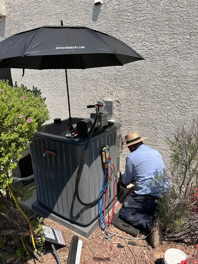 HVAC technician performing outdoor AC maintenance in South Middleton
