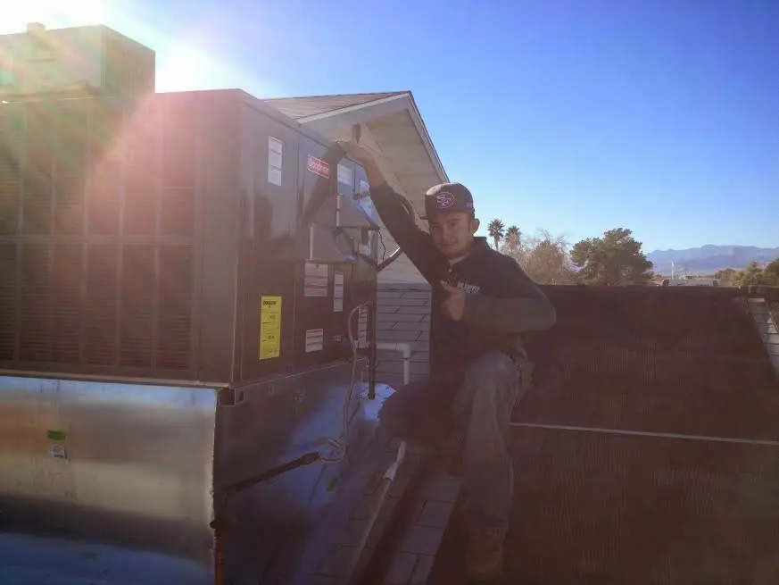 HVAC technician performing Boiler Repair on a rooftop unit in South Middleton